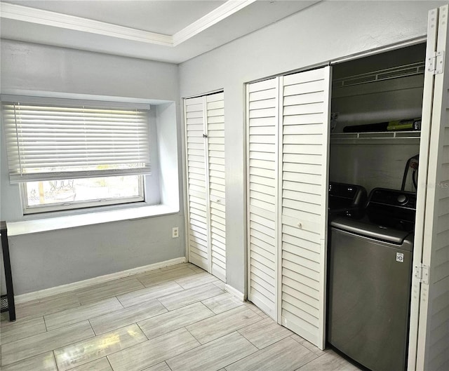3545 7th Ave N, Saint Petersburg, FL 33713 - bedroom featuring separate washer and dryer, baseboards, wood finish floors, two closets, and crown molding