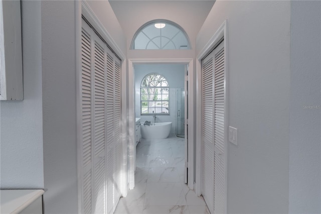 1084 Berkshire Ln, Tarpon Springs, FL 34688 - hall featuring marble look tile flooring