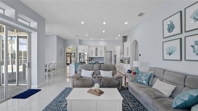 1084 Berkshire Ln, Tarpon Springs, FL 34688 - living area featuring light marble finish floors, recessed lighting, and arched walkways