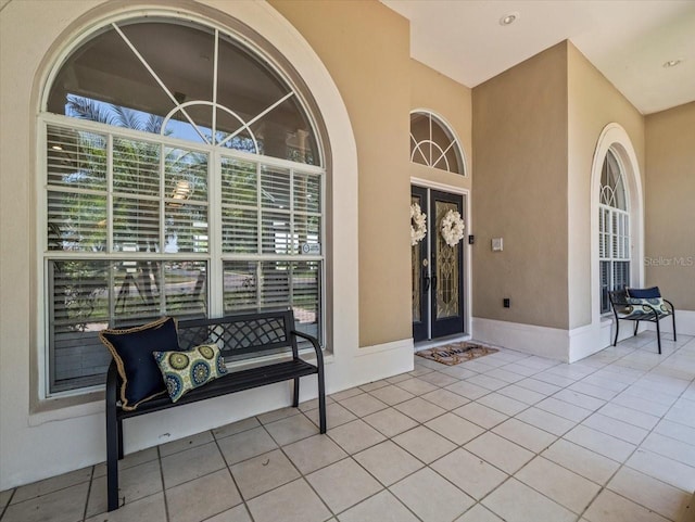 1084 Berkshire Ln, Tarpon Springs, FL 34688 - doorway to property with stucco siding and covered porch