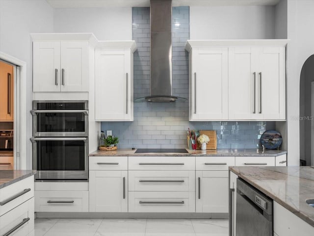 1084 Berkshire Ln, Tarpon Springs, FL 34688 - kitchen featuring wall chimney exhaust hood, dishwashing machine, double oven, and white cabinets