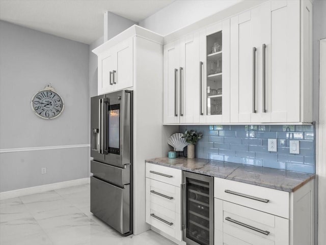 1084 Berkshire Ln, Tarpon Springs, FL 34688 - kitchen featuring stainless steel refrigerator with ice dispenser, beverage cooler, dark stone countertops, light marble finish floors, and white cabinetry