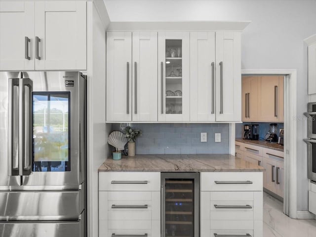 1084 Berkshire Ln, Tarpon Springs, FL 34688 - bar featuring stainless steel appliances, beverage cooler, decorative backsplash, and light marble finish flooring