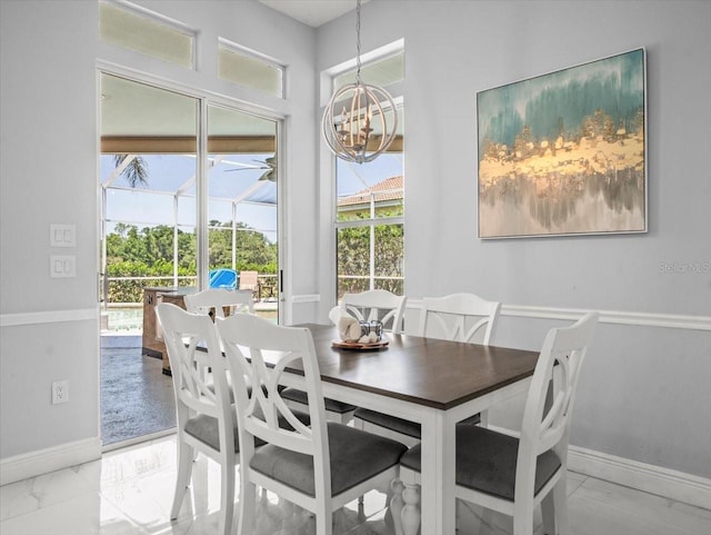 1084 Berkshire Ln, Tarpon Springs, FL 34688 - dining area featuring baseboards, a chandelier, and marble finish floors