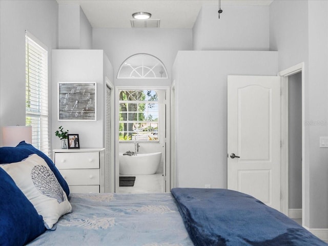 1084 Berkshire Ln, Tarpon Springs, FL 34688 - bedroom with marble look tiles and ensuite bath