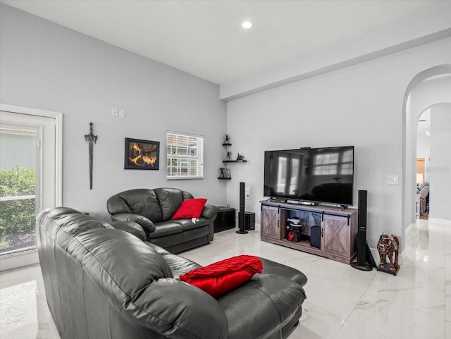 1084 Berkshire Ln, Tarpon Springs, FL 34688 - living room with arched walkways, light marble finish floors, and recessed lighting