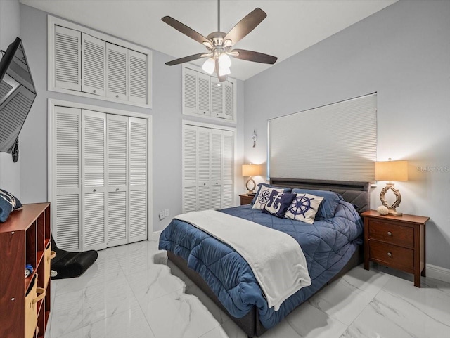 1084 Berkshire Ln, Tarpon Springs, FL 34688 - bedroom with marble finish floors, baseboards, a ceiling fan, and multiple closets