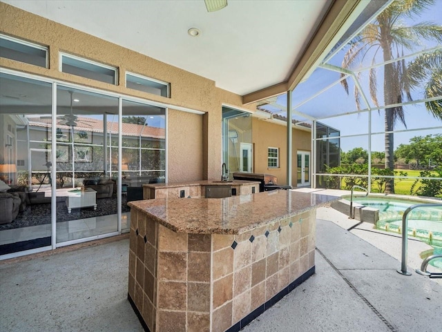 1084 Berkshire Ln, Tarpon Springs, FL 34688 - view of patio with area for grilling, glass enclosure, and an outdoor pool