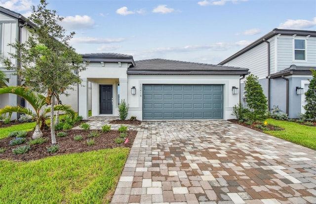 10414 Cross River Trl, Parrish, FL 34219 - view of front of home featuring decorative driveway, stucco siding, and an attached garage