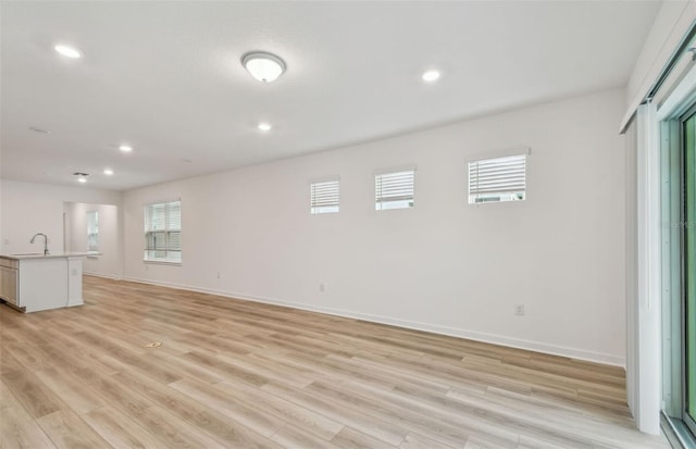 10414 Cross River Trl, Parrish, FL 34219 - unfurnished living room with healthy amount of natural light, light wood-style floors, and recessed lighting