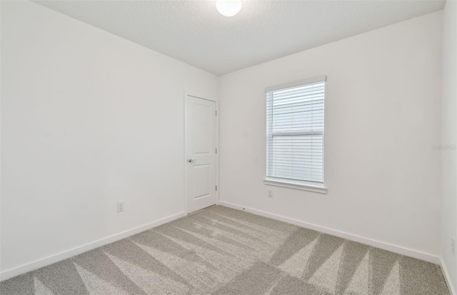 10414 Cross River Trl, Parrish, FL 34219 - carpeted spare room with baseboards and a textured ceiling