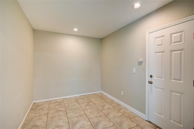spare room featuring light tile patterned floors, baseboards, and recessed lighting