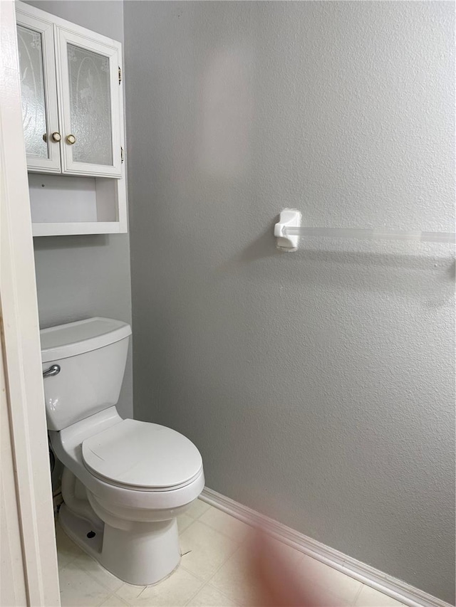 bathroom featuring toilet and baseboards