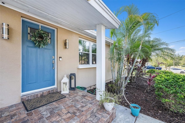 property entrance with stucco siding