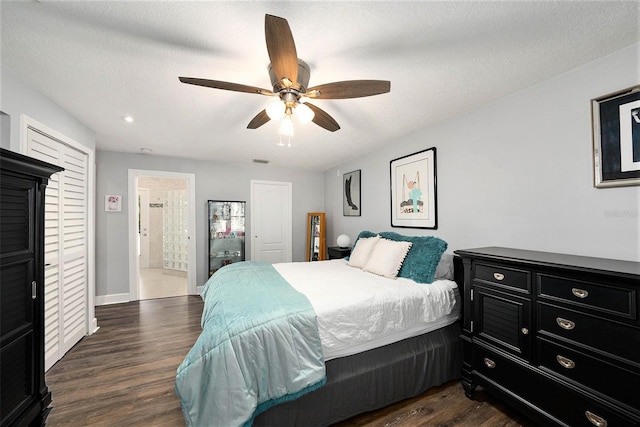 bedroom with baseboards, ensuite bath, ceiling fan, dark wood-style floors, and visible vents