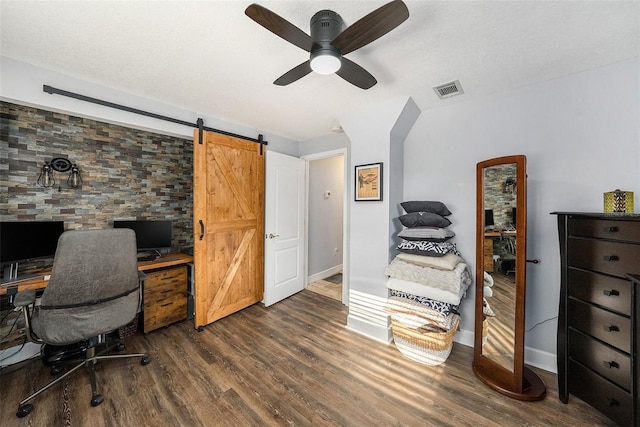 office featuring wood finished floors, visible vents, a ceiling fan, and baseboards