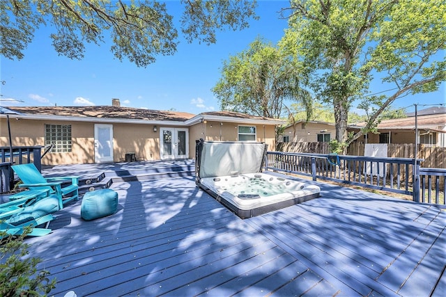 wooden deck featuring fence and french doors