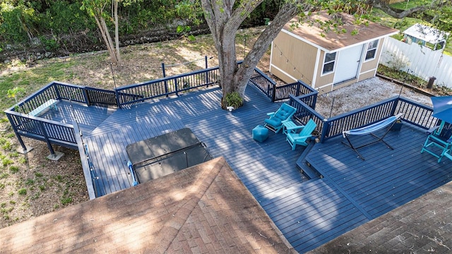 wooden deck with fence and an outbuilding