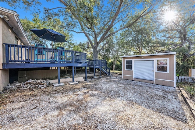 view of yard featuring a wooden deck, stairs, and an outdoor structure