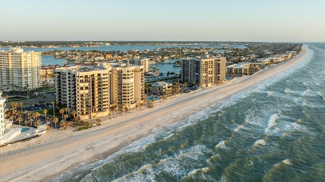 drone / aerial view with a city view, a view of the beach, and a water view