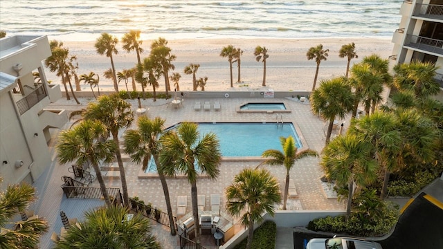 community pool with a beach view and a water view