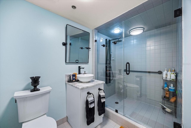 full bathroom with tile patterned floors, vanity, a stall shower, and toilet