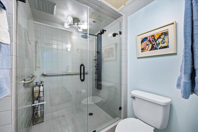 full bath with toilet and a shower stall