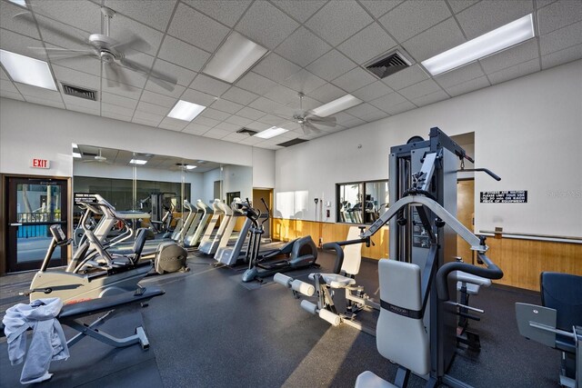 gym featuring visible vents, a paneled ceiling, and ceiling fan