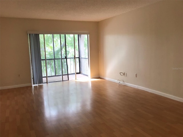 2625 State Road 590 Unit 1822, Clearwater, FL 33759 - empty room with baseboards, wood finished floors, and a textured ceiling