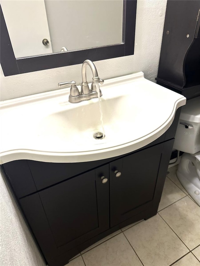 2625 State Road 590 Unit 1822, Clearwater, FL 33759 - half bathroom with tile patterned floors, toilet, vanity, and a textured wall