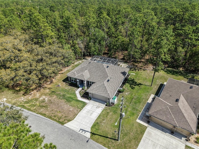 drone / aerial view featuring a forest view