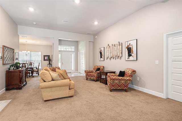 living room with a chandelier, carpet flooring, visible vents, and baseboards