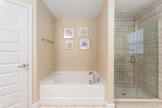 full bath featuring a shower stall and a bath