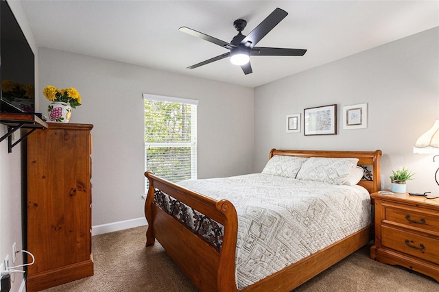 carpeted bedroom featuring baseboards and a ceiling fan