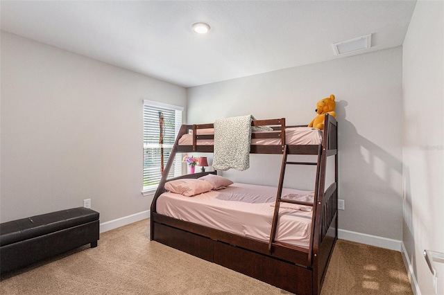carpeted bedroom featuring baseboards and visible vents