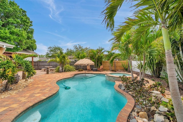 4815 Plantation Dr, Tampa, FL 33615 - view of swimming pool with a patio, a fenced backyard, and a pool with connected hot tub