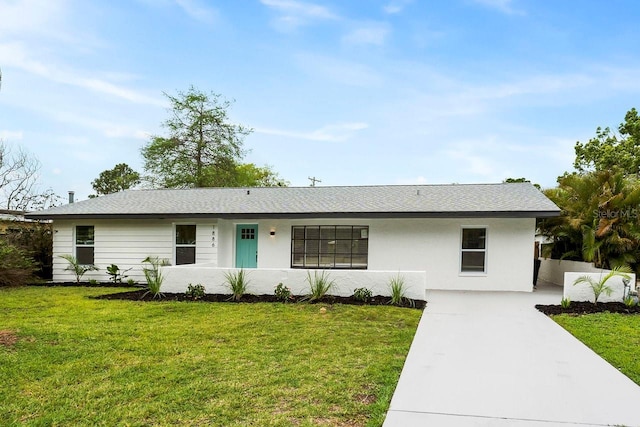 1886 San Mateo Dr, Dunedin, FL 34698 - ranch-style home with stucco siding, a front lawn, and concrete driveway