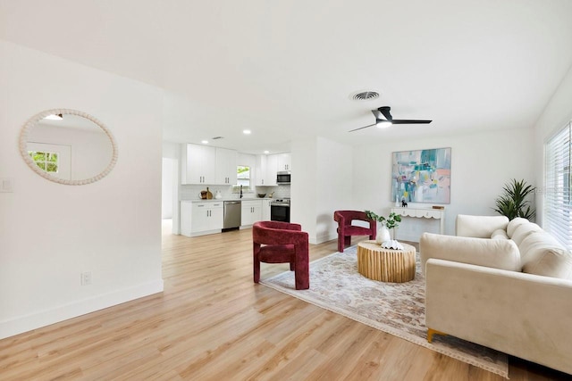 1886 San Mateo Dr, Dunedin, FL 34698 - living area with light wood finished floors, baseboards, visible vents, recessed lighting, and a ceiling fan