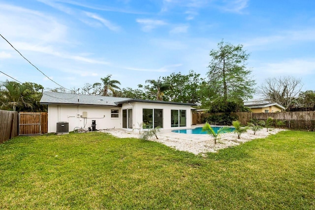1886 San Mateo Dr, Dunedin, FL 34698 - rear view of house featuring cooling unit, a yard, a fenced in pool, and a fenced backyard