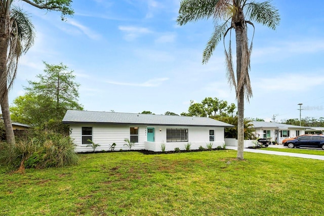 1886 San Mateo Dr, Dunedin, FL 34698 - ranch-style home featuring driveway and a front yard