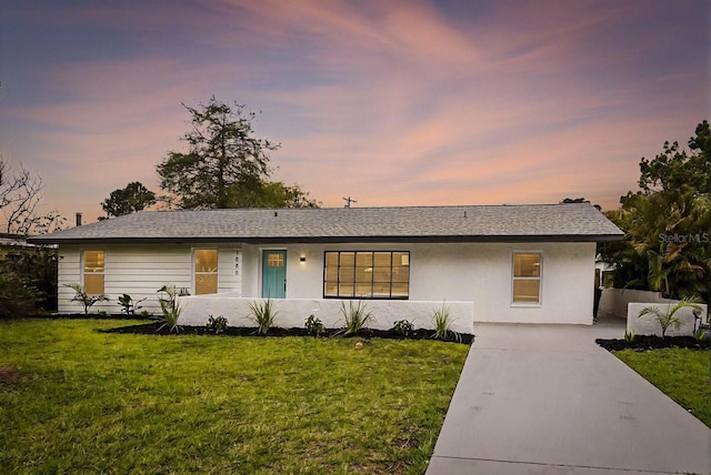 1886 San Mateo Dr, Dunedin, FL 34698 - ranch-style house with stucco siding and a yard