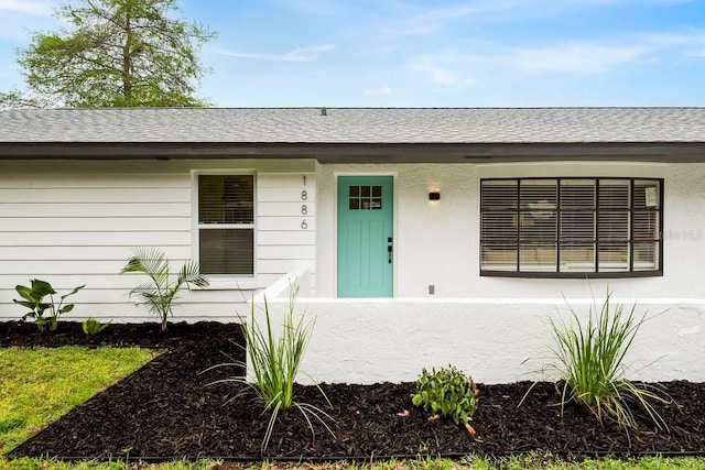 1886 San Mateo Dr, Dunedin, FL 34698 - doorway to property with a shingled roof
