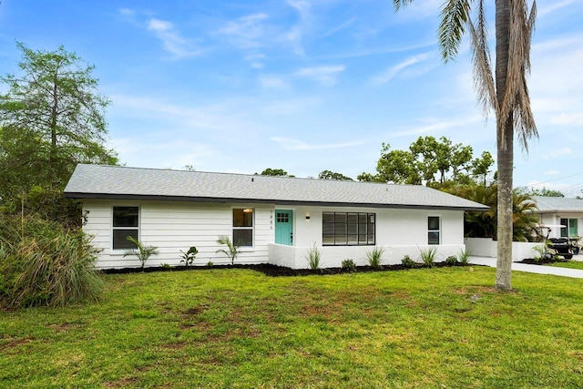1886 San Mateo Dr, Dunedin, FL 34698 - ranch-style home with a front lawn and stucco siding