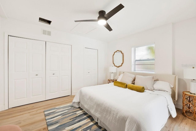 1886 San Mateo Dr, Dunedin, FL 34698 - bedroom featuring attic access, light wood-style flooring, visible vents, and a ceiling fan