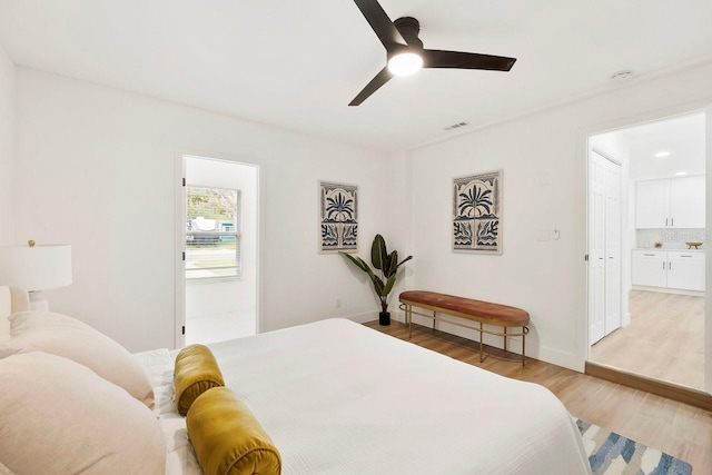 1886 San Mateo Dr, Dunedin, FL 34698 - bedroom with ensuite bathroom, ceiling fan, light wood finished floors, baseboards, and visible vents