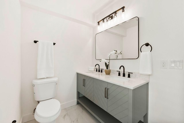 1886 San Mateo Dr, Dunedin, FL 34698 - bathroom featuring baseboards, a sink, marble finish floor, and toilet