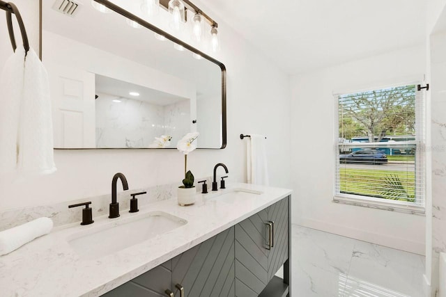 1886 San Mateo Dr, Dunedin, FL 34698 - bathroom with visible vents, a sink, marble finish floor, and double vanity