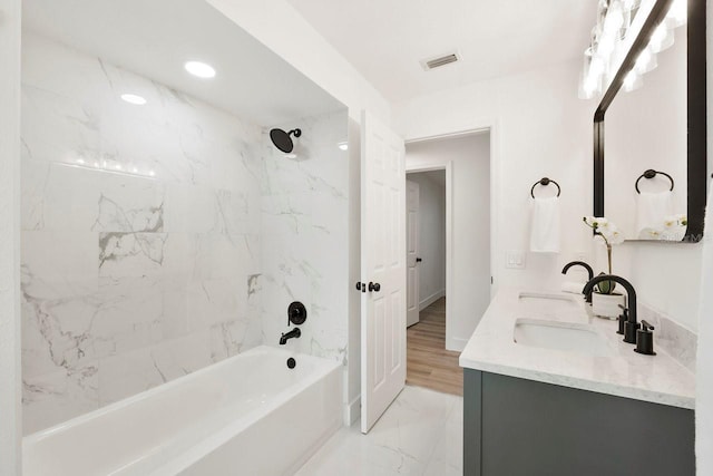 1886 San Mateo Dr, Dunedin, FL 34698 - full bath with a sink,  shower combination, marble finish floor, double vanity, and visible vents