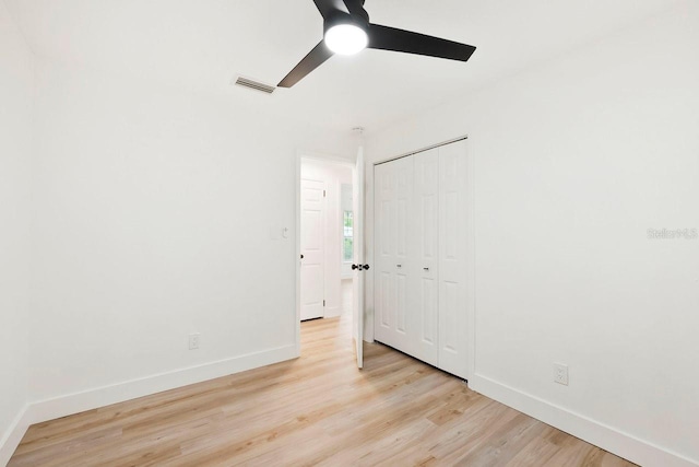 1886 San Mateo Dr, Dunedin, FL 34698 - unfurnished bedroom with light wood-style flooring, a closet, and baseboards