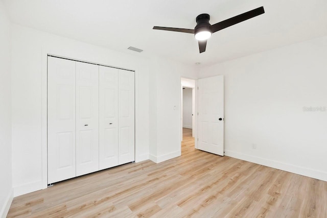 1886 San Mateo Dr, Dunedin, FL 34698 - unfurnished bedroom featuring a closet, light wood-type flooring, visible vents, and baseboards